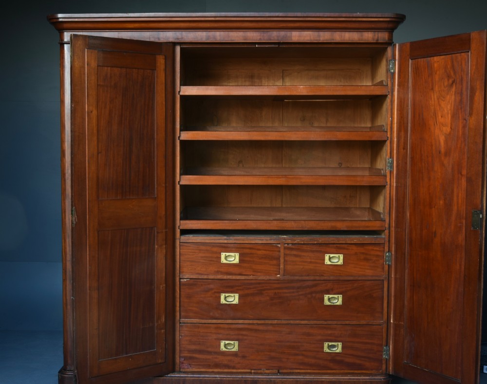 A Victorian mahogany triple wardrobe featuring two outer panelled doors, a central mirrored door, and a moulded cornice top. View IV