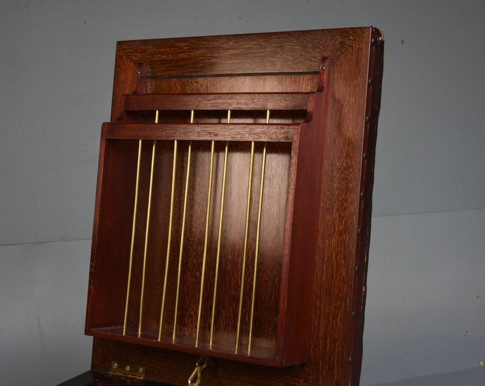 A 19th-century inlaid mahogany duet piano stool featuring two dark brown leather padded seats trimmed with brass studs and central foliate marquetry along the front frame. View VI