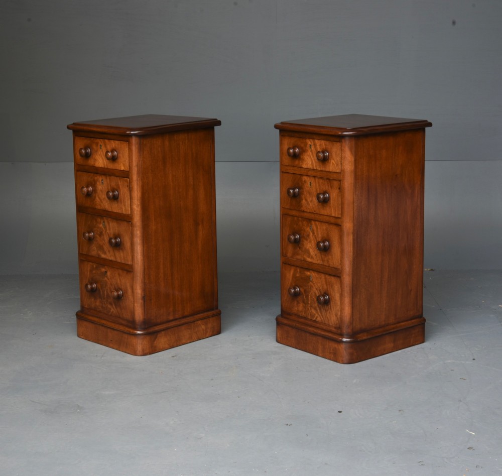 A matching pair of tall Victorian mahogany bedside chests featuring four graduated drawers with turned wooden handles and a plinth base. View III