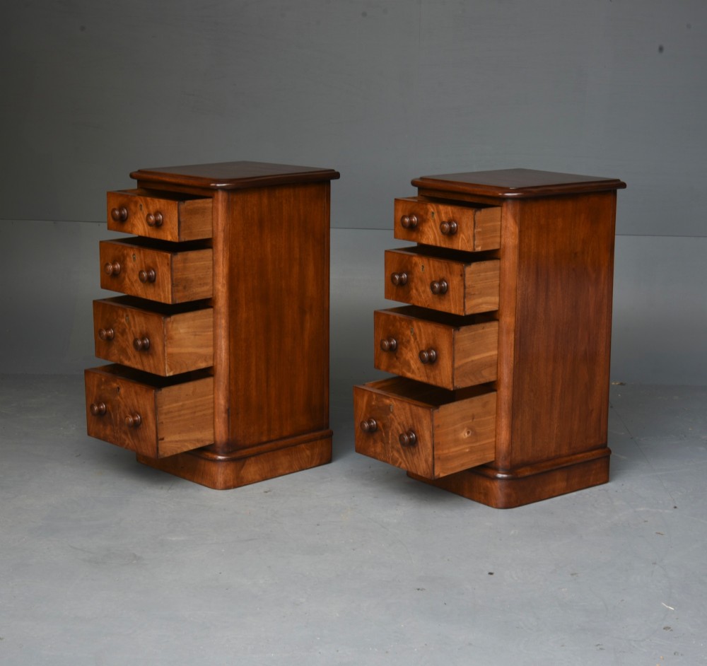 A matching pair of tall Victorian mahogany bedside chests featuring four graduated drawers with turned wooden handles and a plinth base. View IV