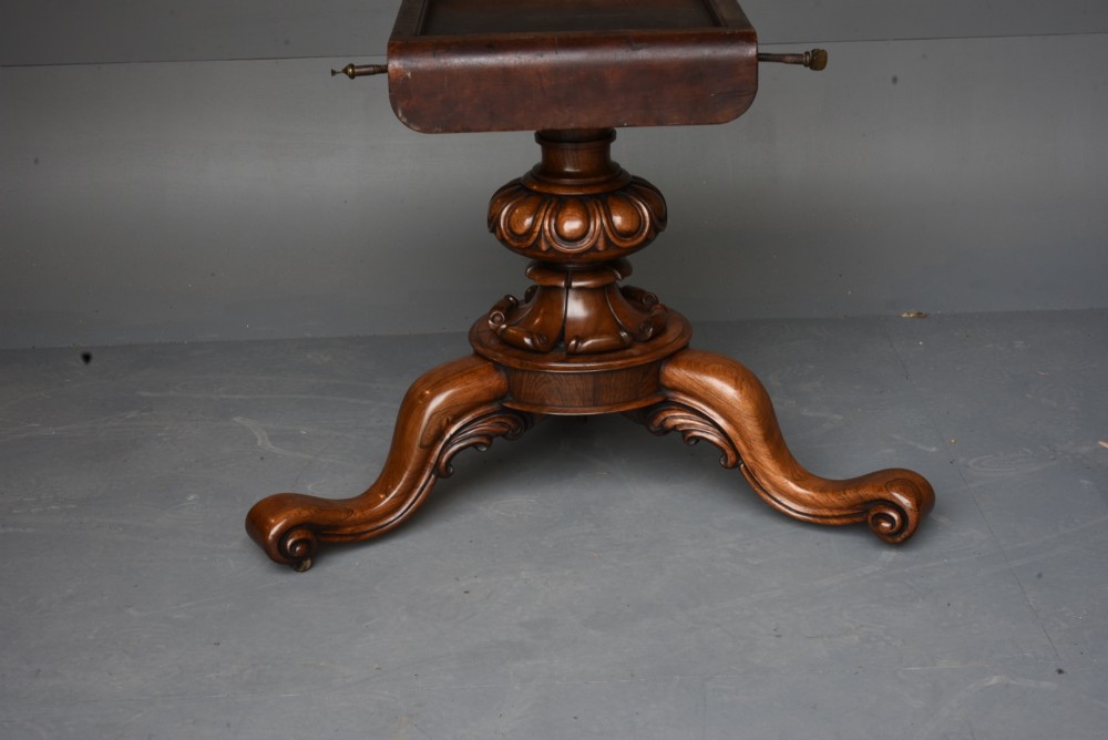 A nineteenth-century circular mahogany tilt-top table with radial flame mahogany veneering set on a carved tripod base with scroll feet. View V