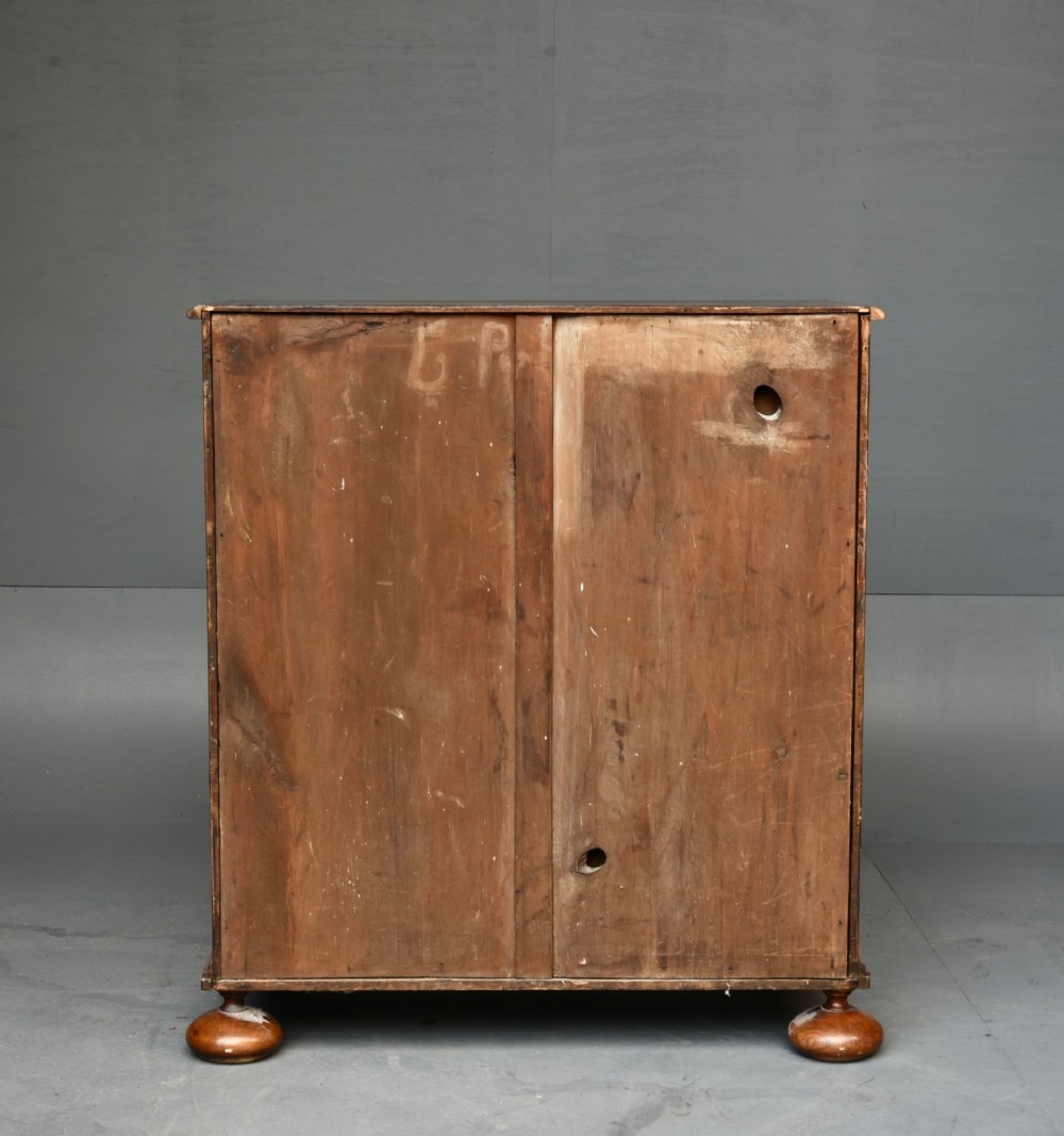 A 19th-century Queen Anne style walnut chest of drawers featuring a two-over-three drawer configuration with brass drop handles and bun feet. View VII