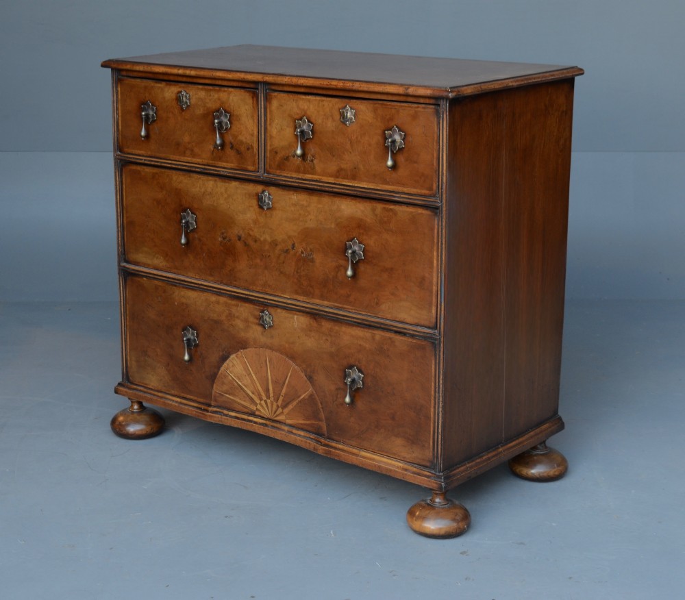 A 19th-century Queen Anne style walnut chest of drawers with two short over two long drawers, brass drop handles, turned bun feet, and a fan-shaped sunburst inlay. View III