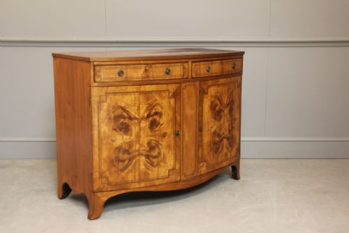 fig 1. A 19th century Bow fronted Satinwood side cabinet