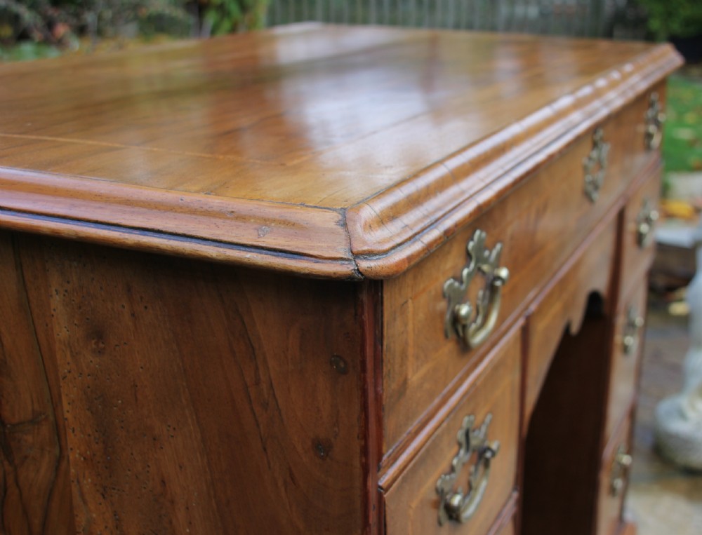 An early 18th century walnut kneehole desk. View III