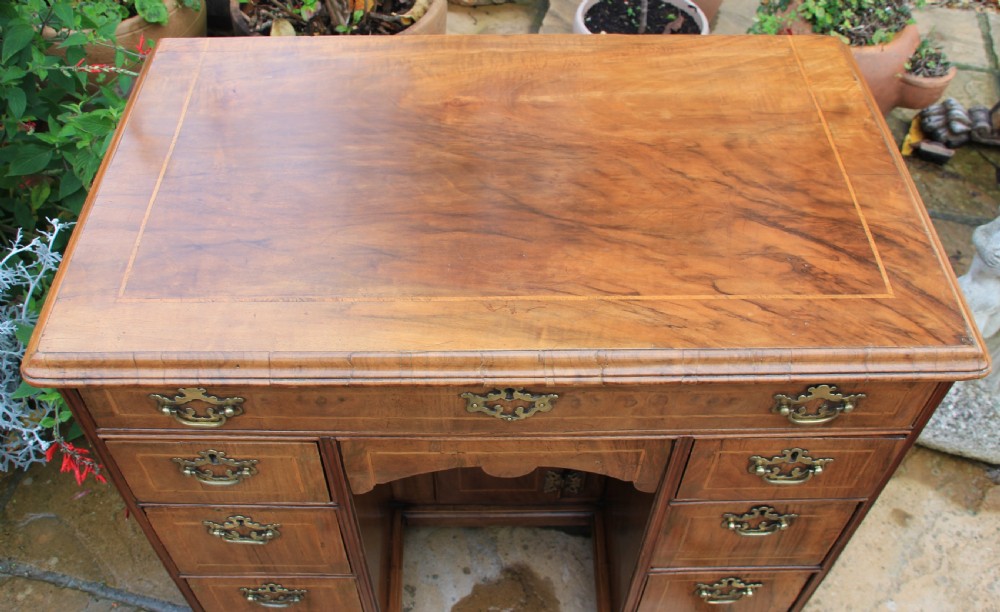 An early 18th century walnut kneehole desk. View IV