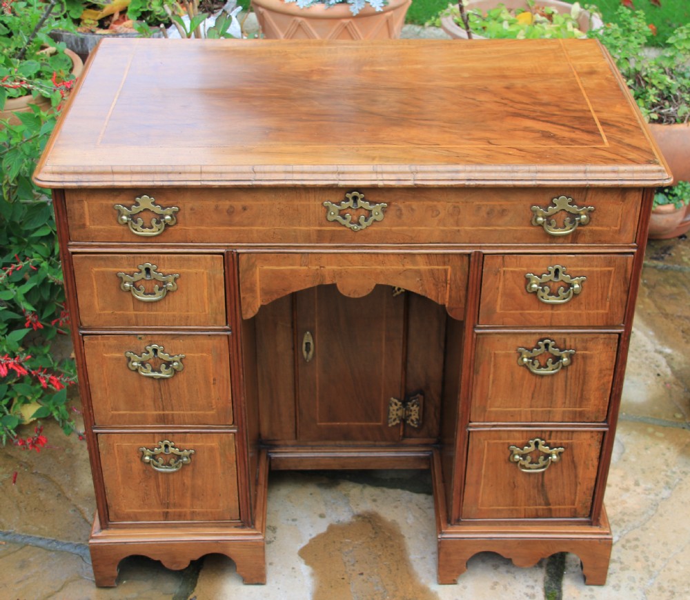 An early 18th century walnut kneehole desk. View V