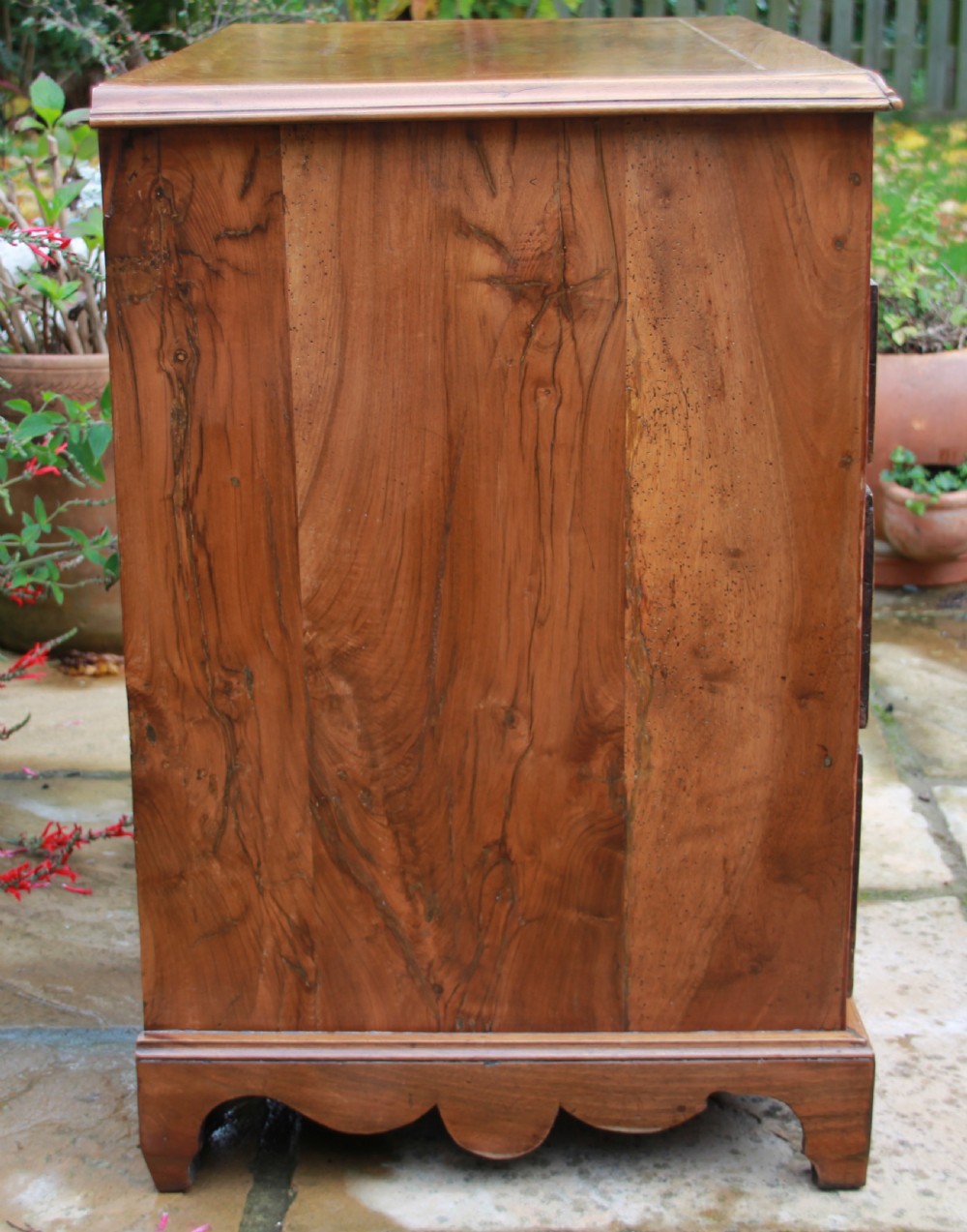 An early 18th century walnut kneehole desk. View IX