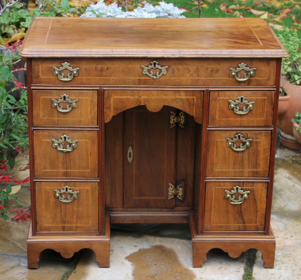 An early 18th century walnut kneehole desk. View X