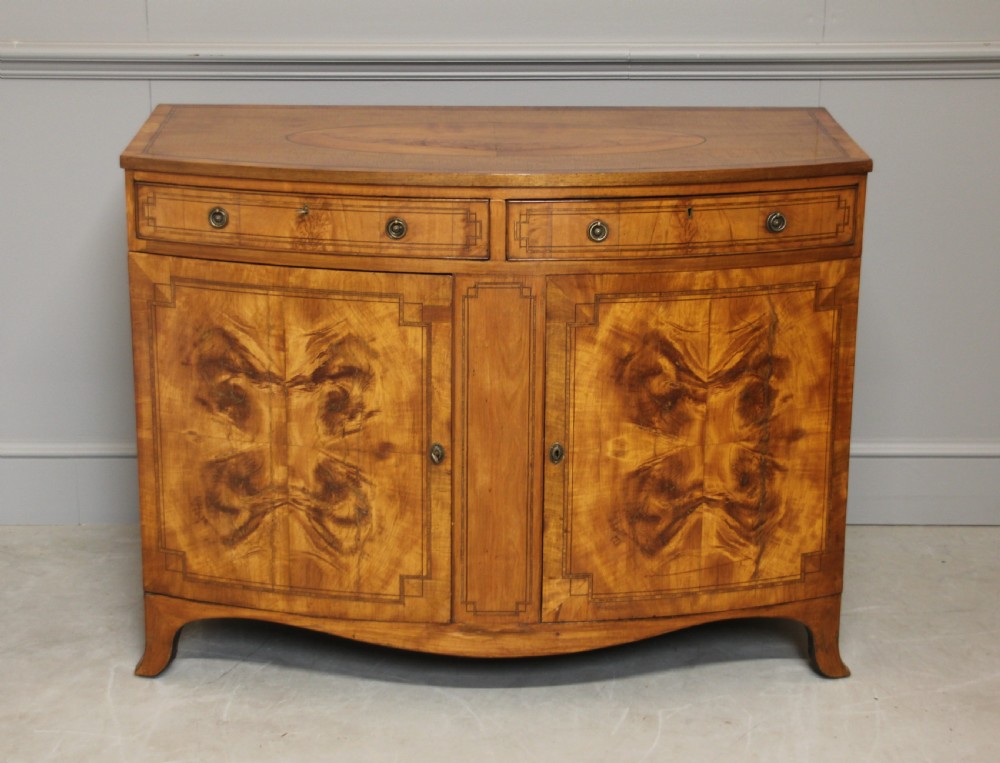 A 19th century Bow fronted Satinwood side cabinet
