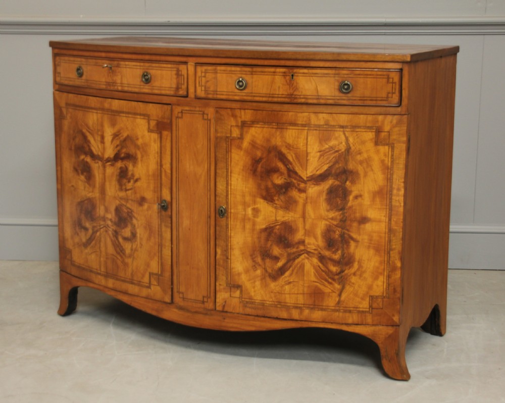 A 19th century Bow fronted Satinwood side cabinet View III