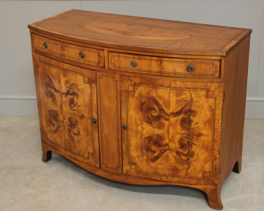 A 19th century Bow fronted Satinwood side cabinet View IV