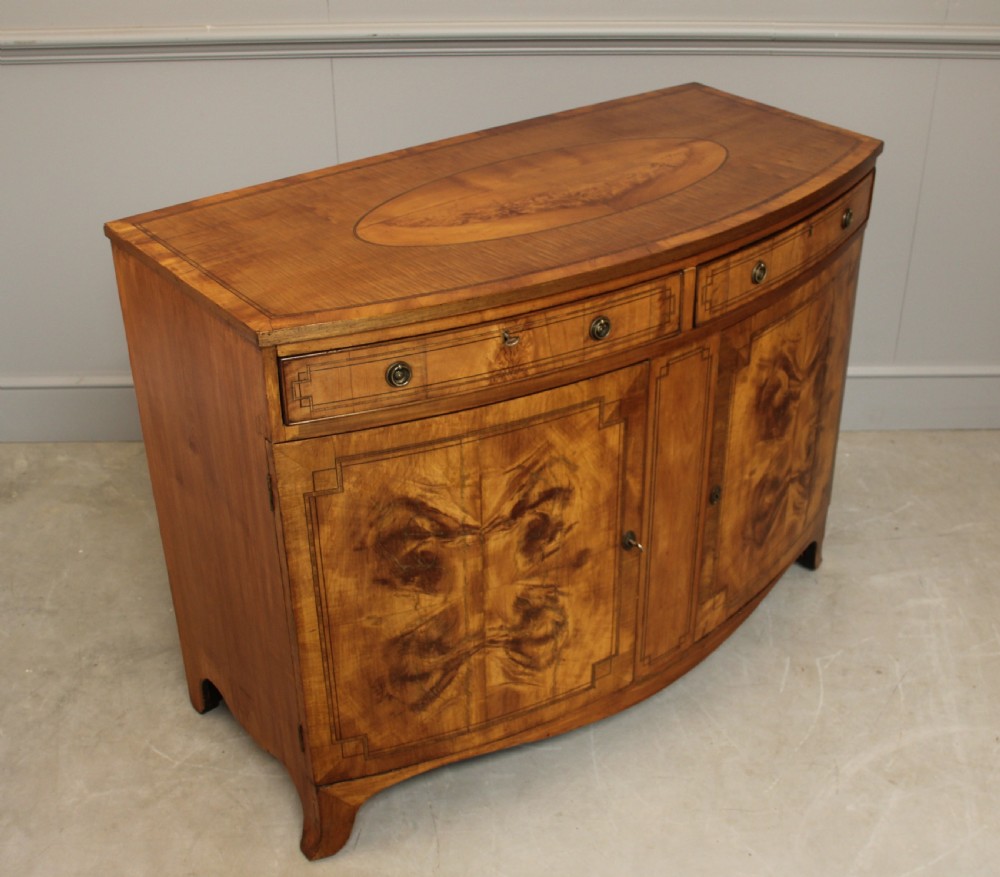 A 19th century Bow fronted Satinwood side cabinet View V