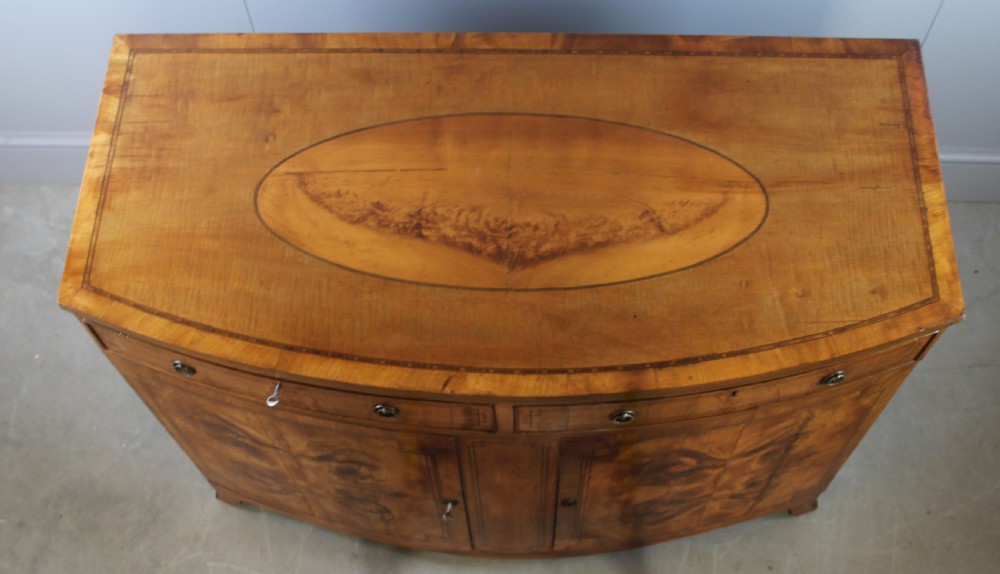 A 19th century Bow fronted Satinwood side cabinet View VI
