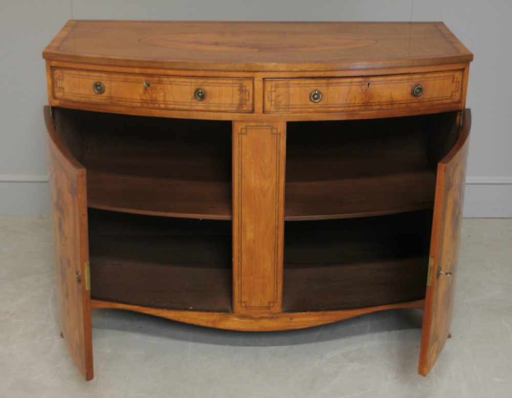 A 19th century Bow fronted Satinwood side cabinet View VII