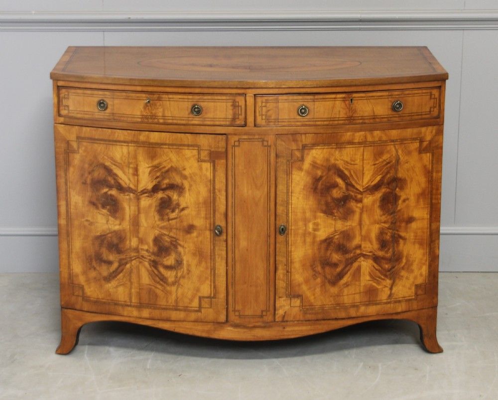 A 19th century Bow fronted Satinwood side cabinet View VIII