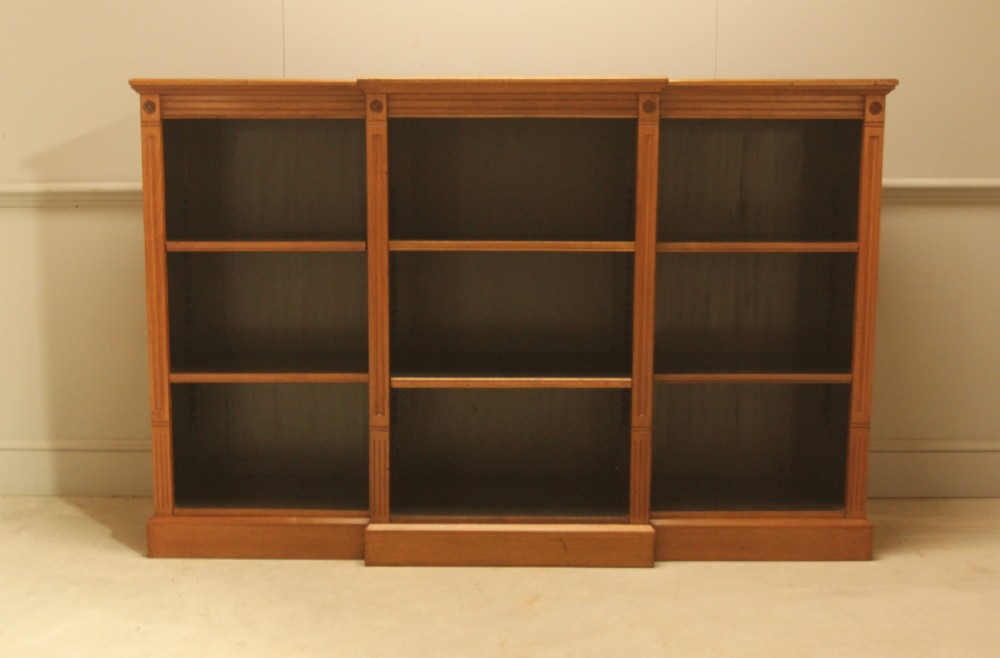 A pair of Edwardian mahogany low open breakfront bookcases featuring three bays and plinth bases. View II