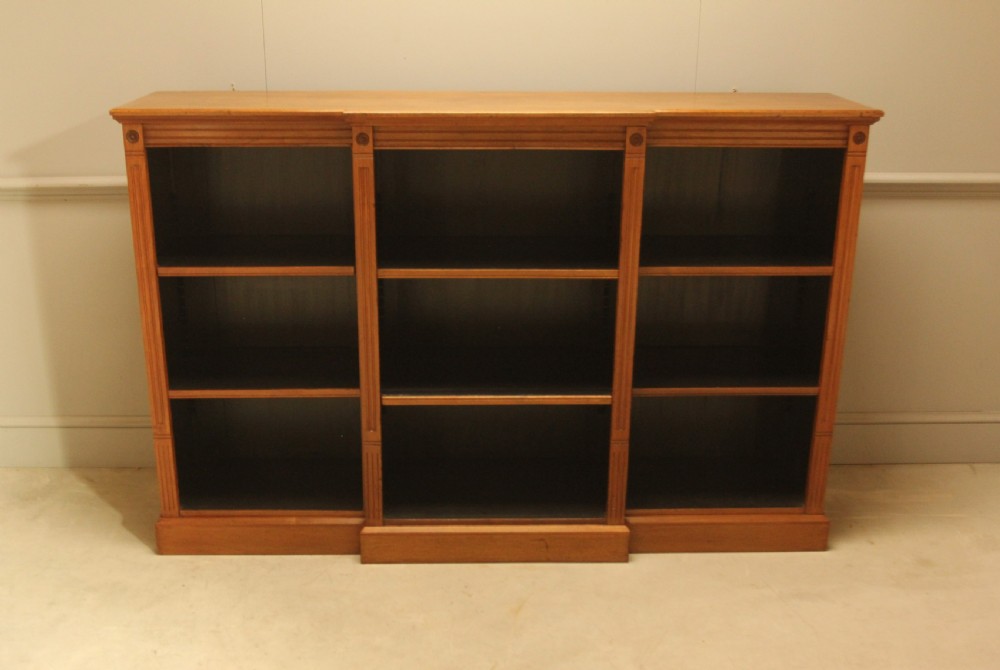 A pair of Edwardian mahogany low open breakfront bookcases featuring three bays and plinth bases. View III