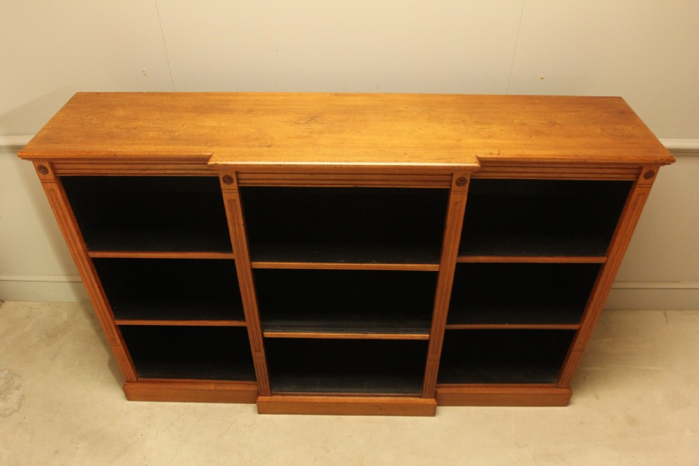 A pair of Edwardian mahogany low open breakfront bookcases featuring three bays and plinth bases. View IV