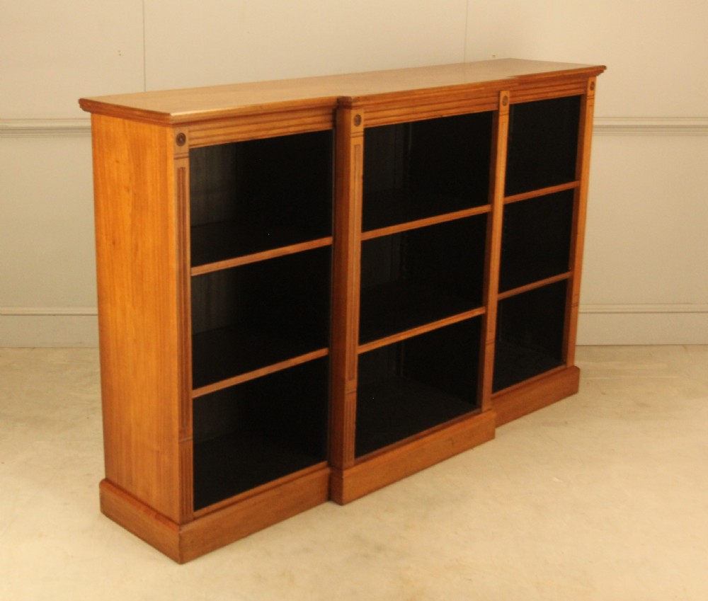 A pair of Edwardian mahogany low open breakfront bookcases featuring three bays and plinth bases. View V