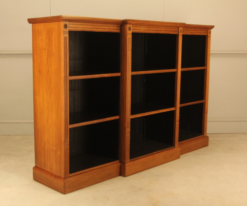 A pair of Edwardian mahogany low open breakfront bookcases featuring three bays and plinth bases. View VI