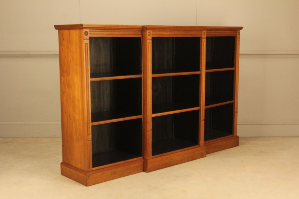 A pair of Edwardian mahogany low open breakfront bookcases featuring three bays and plinth bases. View XII