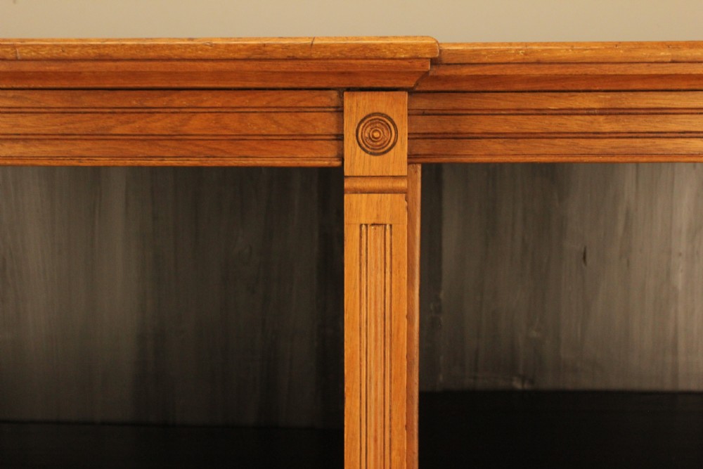 A pair of Edwardian mahogany low open breakfront bookcases featuring three bays and plinth bases. View XV