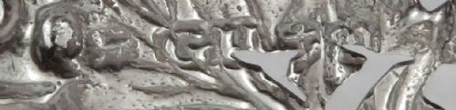 fig 1. An antique sterling silver decanter label formed as grapevine leaves and a bunch of grapes, featuring the word Sherry in raised lettering with a suspension chain.