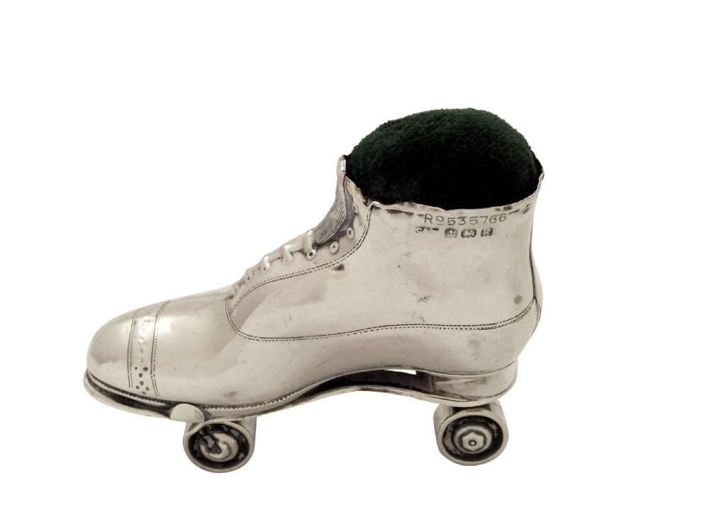 A pair of Edwardian sterling silver roller skate boots fitted with dark green velvet pin cushion tops. View VIII