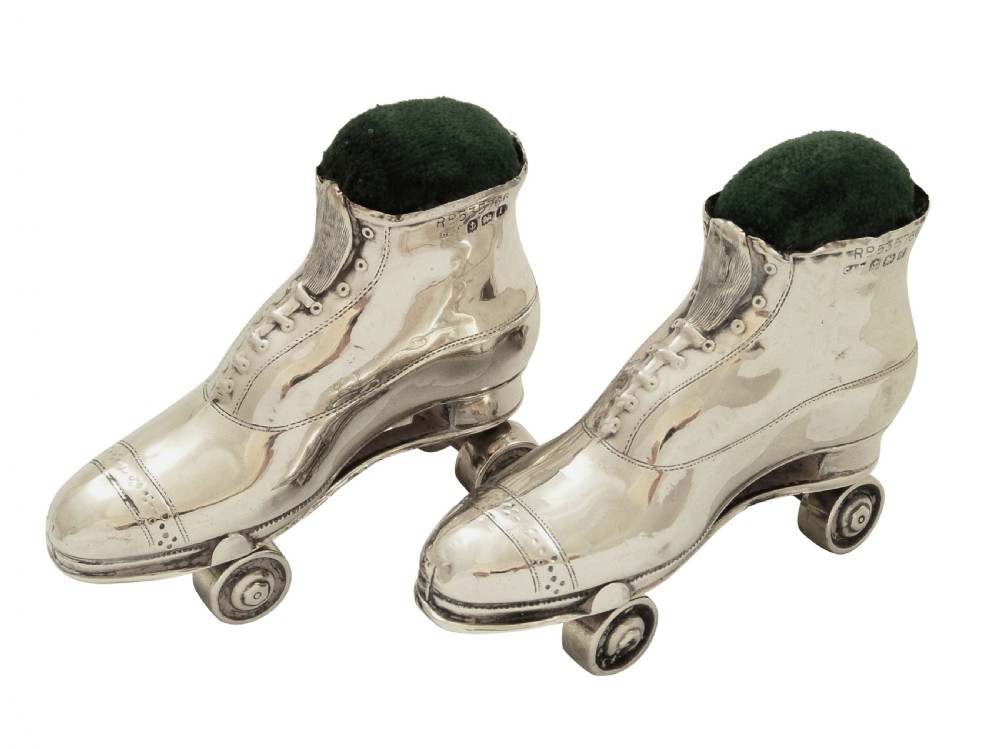 A pair of Edwardian sterling silver roller skate boots fitted with dark green velvet pin cushion tops. View XI