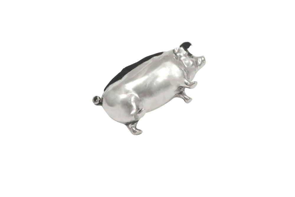 An Edwardian sterling silver novelty pin cushion modelled in the form of a pig with a dark velvet inset cushion along its back. View II