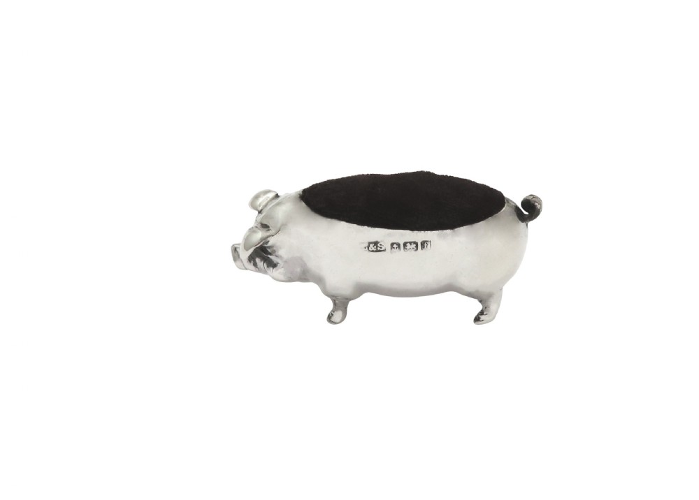 An Edwardian sterling silver novelty pin cushion modelled in the form of a pig with a dark velvet inset cushion along its back. View V