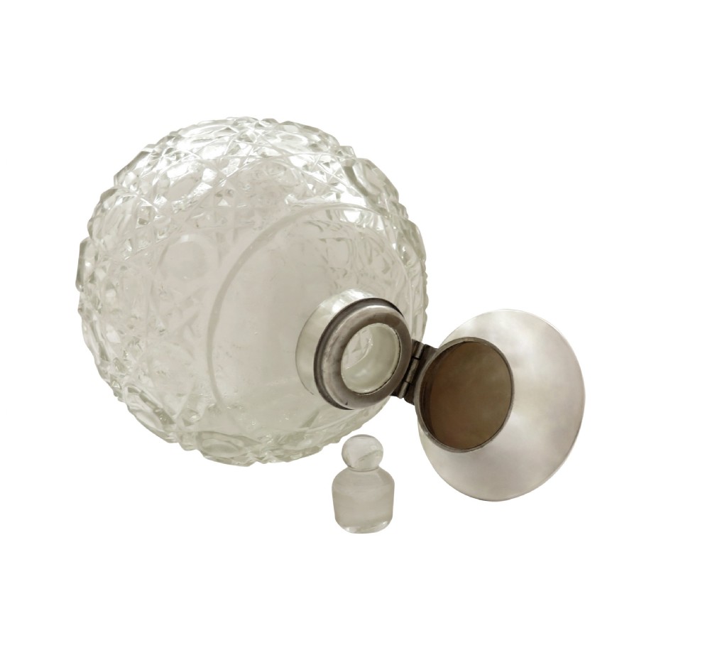 A 1922 globose cut glass scent bottle featuring a sterling silver hinged lid inset with smooth mother of pearl. View II