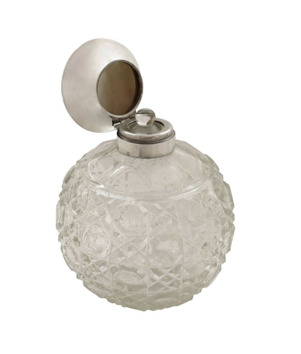 A 1922 globose cut glass scent bottle featuring a sterling silver hinged lid inset with smooth mother of pearl. View IV