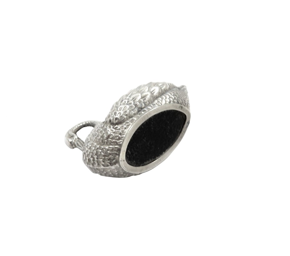 An Edwardian sterling silver pin cushion rendered in the shape of a swan with textured feathers and a dark cushion insert. View V