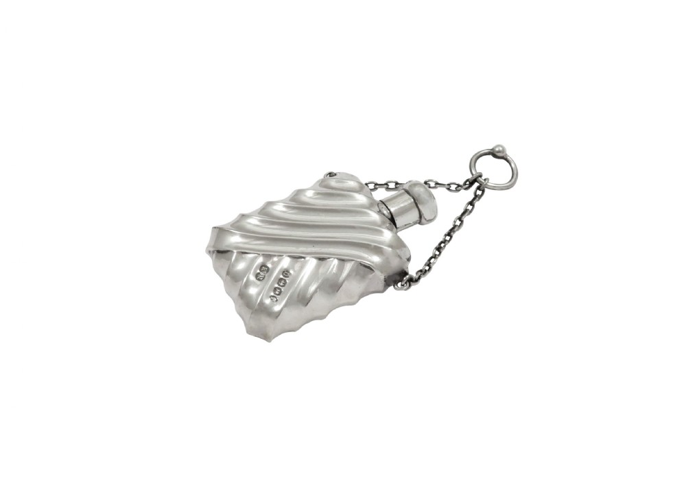 An antique Victorian sterling silver scent flask featuring repousse fluting and an attached hanging chain. View II