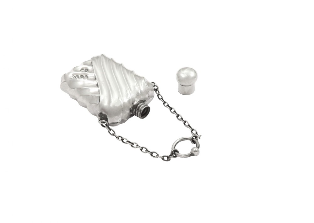 An antique Victorian sterling silver scent flask featuring repousse fluting and an attached hanging chain. View IV