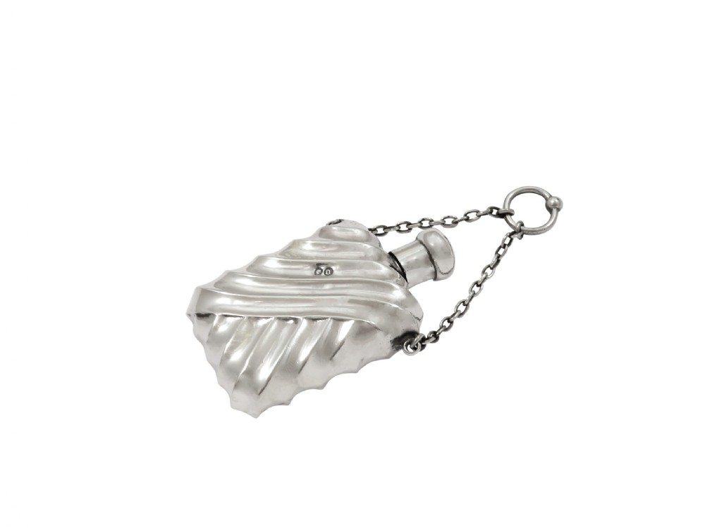 An antique Victorian sterling silver scent flask featuring repousse fluting and an attached hanging chain. View VII