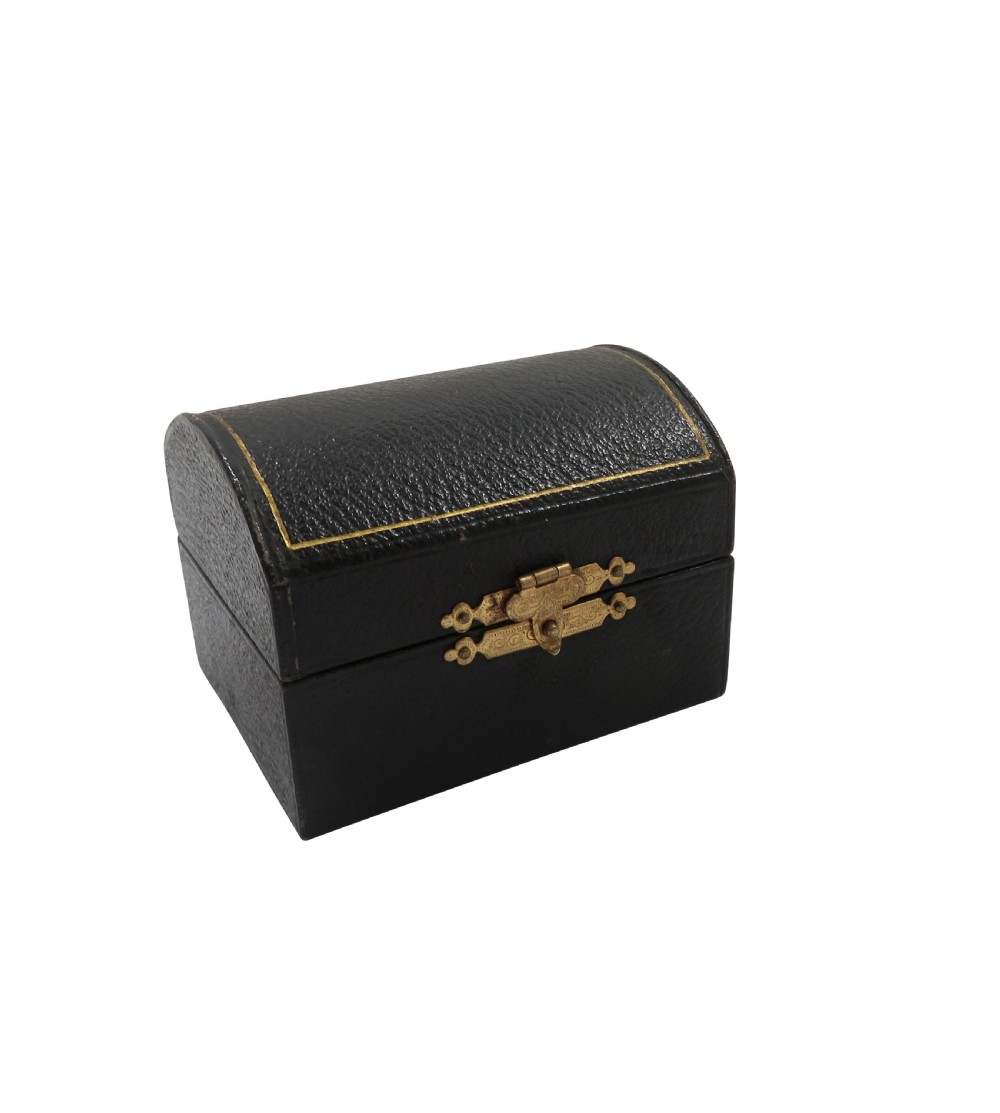 A pair of scalloped sterling silver napkin rings resting inside an open black fitted presentation case lined with cream silk. View VII