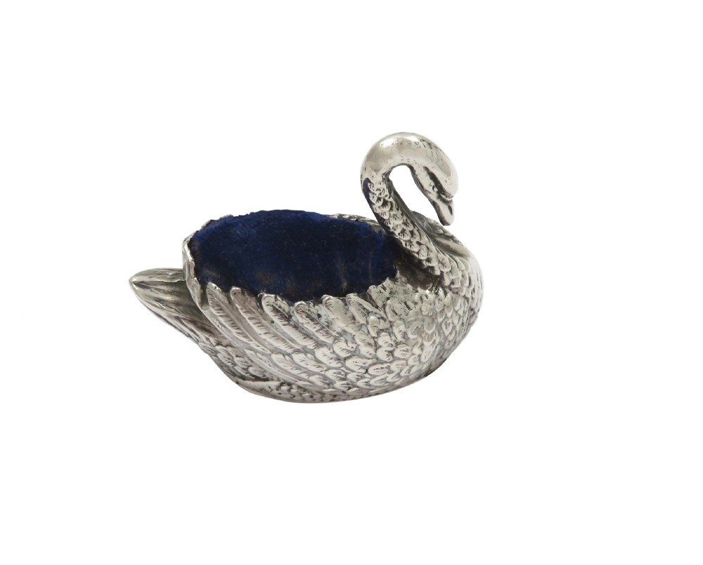 An Edwardian sterling silver pin cushion cast in the form of a swan with a blue velvet fabric insert. View VI