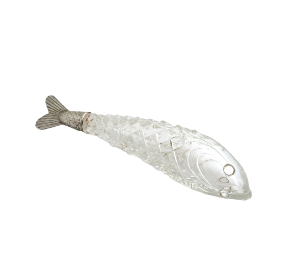 A Victorian clear cut glass scent bottle carved in the shape of a fish with a textured sterling silver tail cap. View V