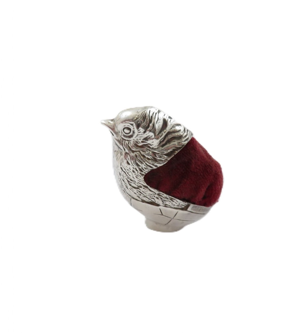 An Edwardian sterling silver novelty pin cushion cast in the form of a small chick with detailed feathers and a red velvet insert. View IV