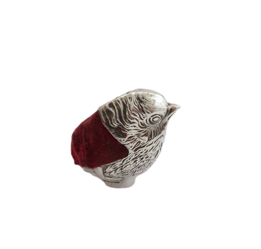 An Edwardian sterling silver novelty pin cushion cast in the form of a small chick with detailed feathers and a red velvet insert. View V