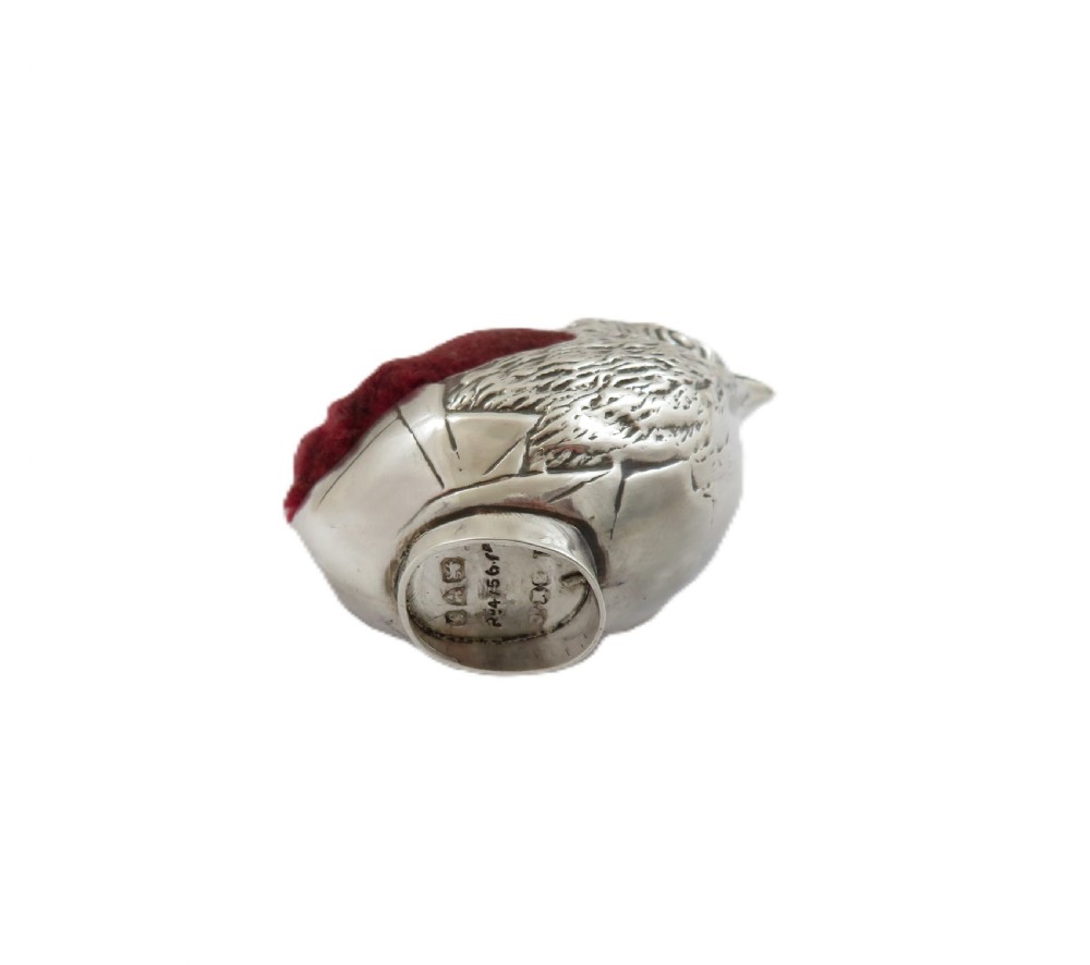 An Edwardian sterling silver novelty pin cushion cast in the form of a small chick with detailed feathers and a red velvet insert. View VI