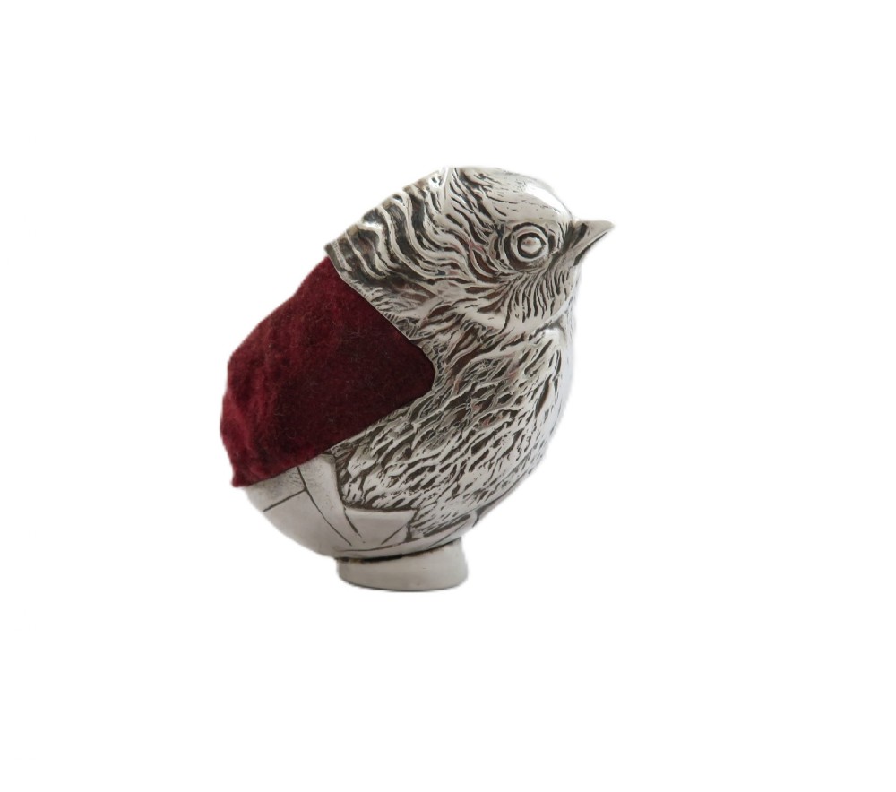 An Edwardian sterling silver novelty pin cushion cast in the form of a small chick with detailed feathers and a red velvet insert. View VII