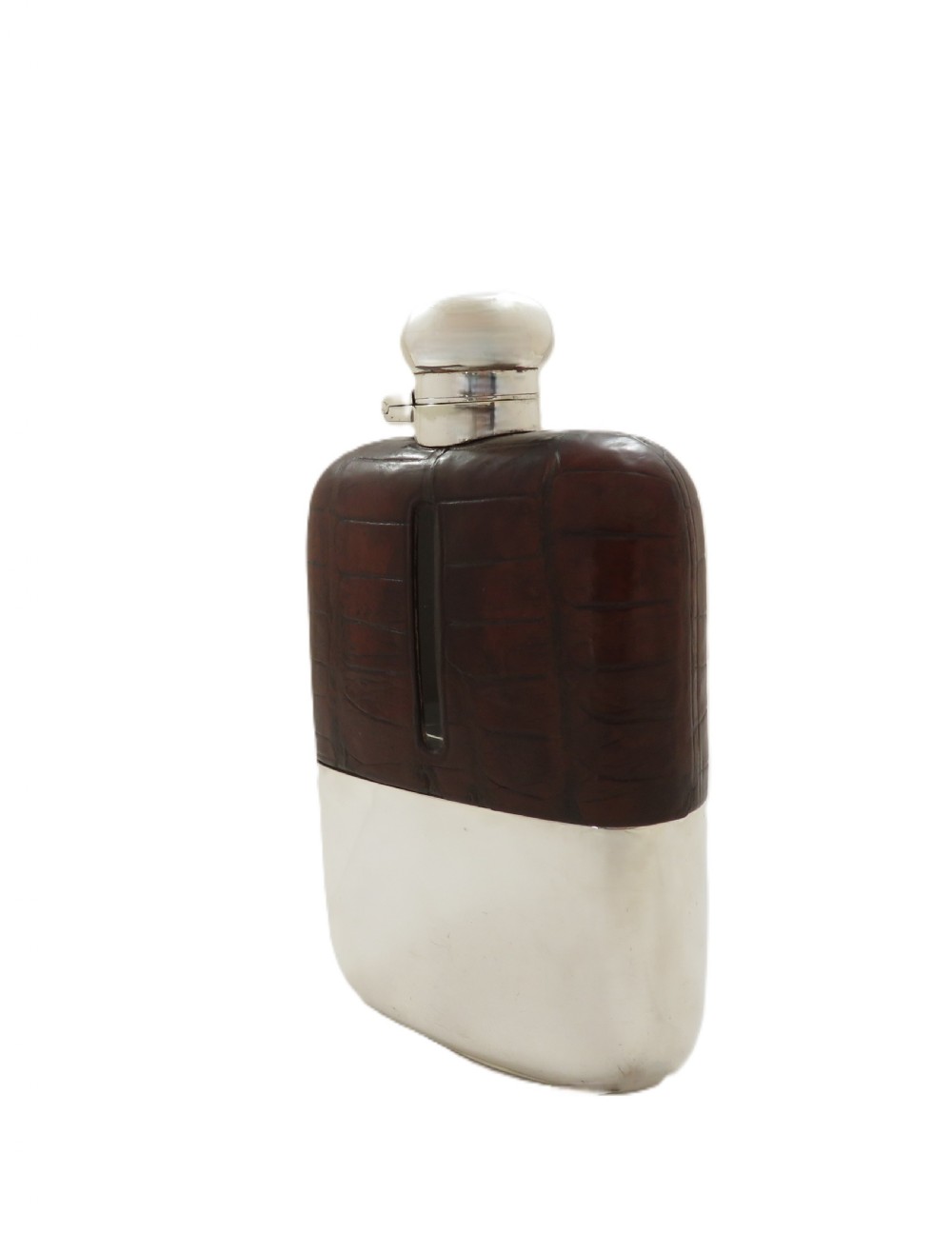 An antique silver-plated and dark brown crocodile leather hip flask featuring a removable base cup and sight level window. View VI