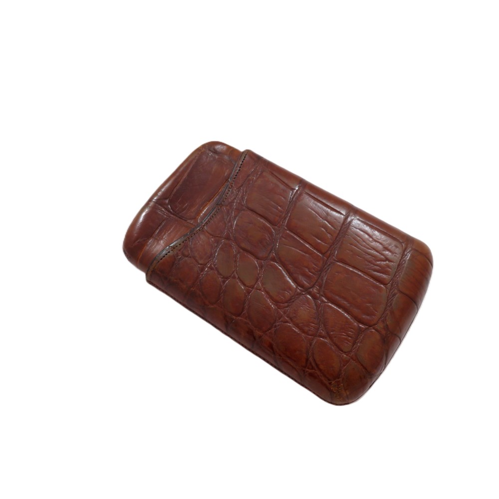 An antique Victorian warm brown crocodile leather pocket cigar case featuring a textured hide exterior and telescopic sleeve design.