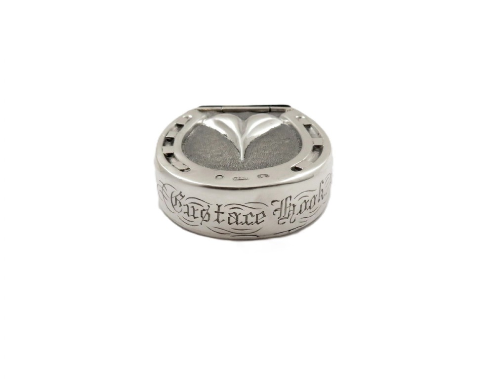 A Victorian sterling silver vesta case in the shape of a horseshoe featuring textured detailing and engraved lettering. View II
