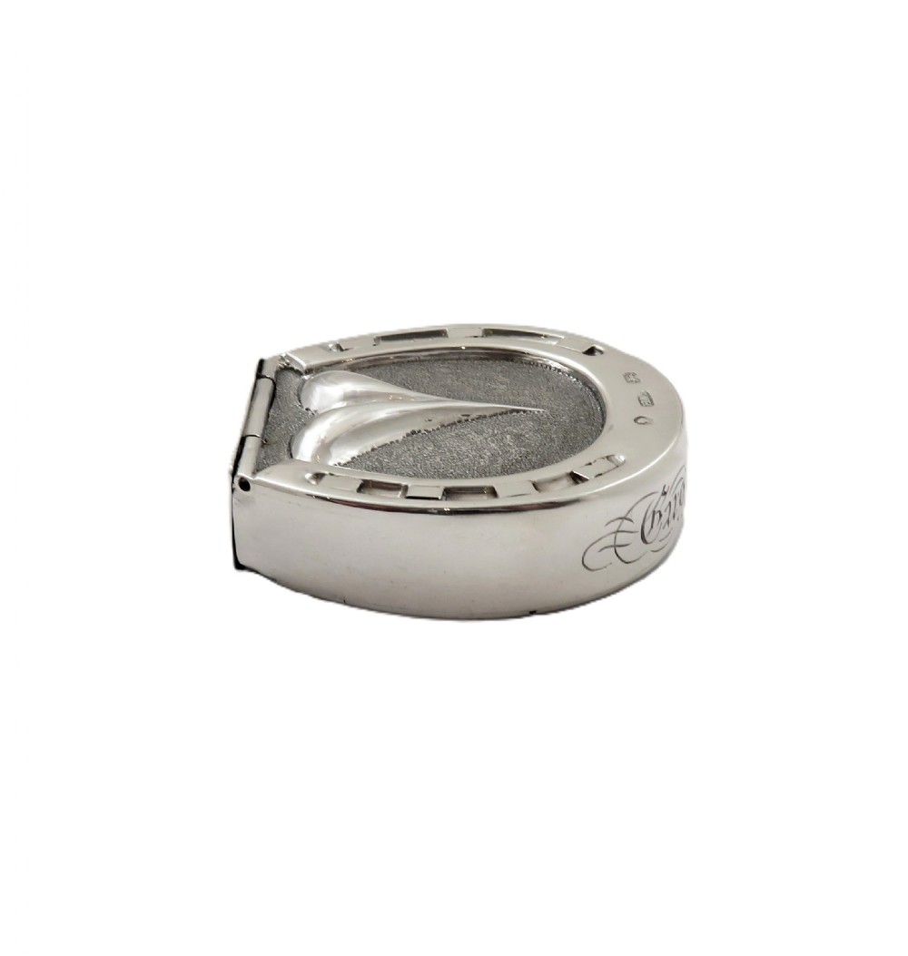 A Victorian sterling silver vesta case in the shape of a horseshoe featuring textured detailing and engraved lettering. View VII