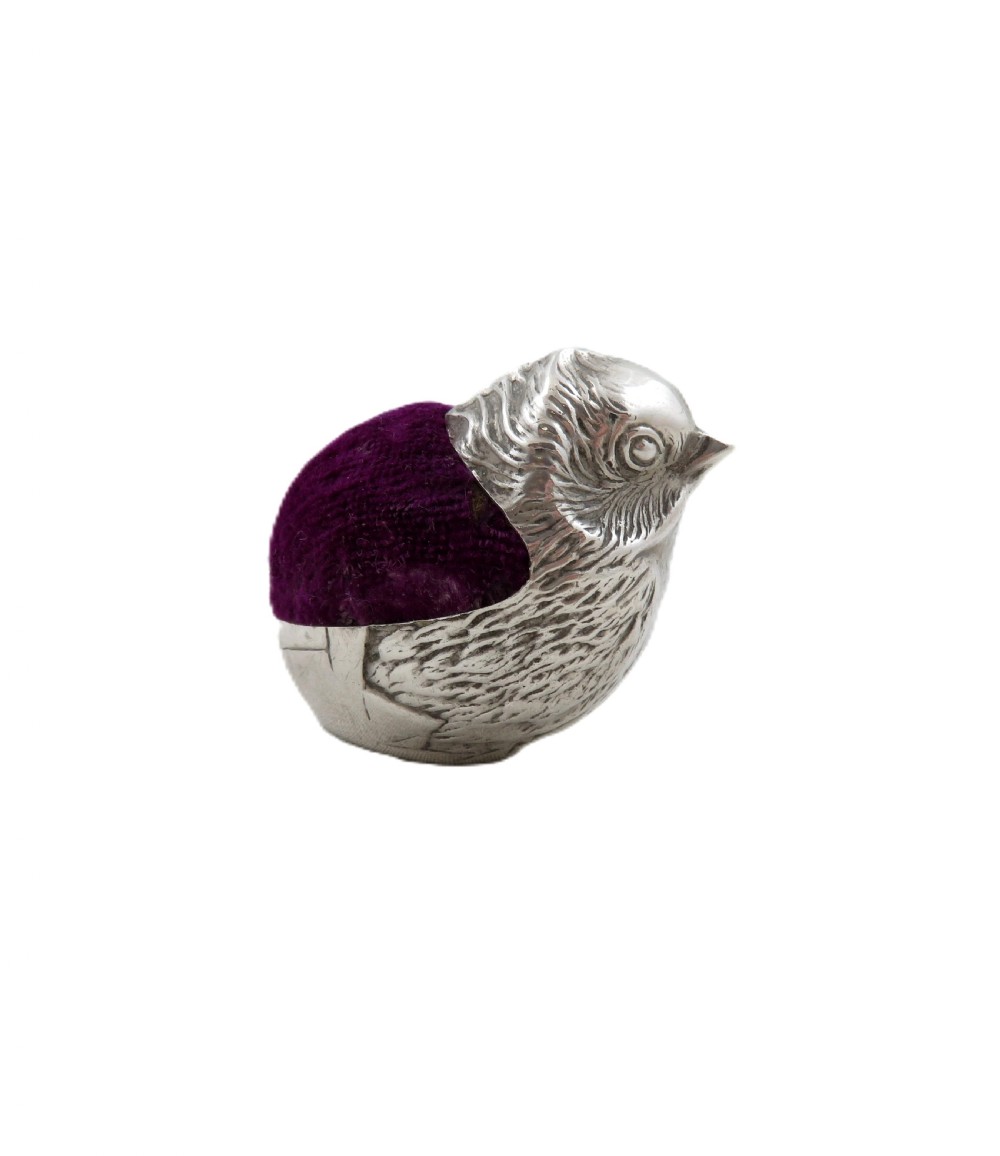 An Edwardian sterling silver pin cushion crafted in the shape of a chick with a purple velvet cushion inset into its back. View III
